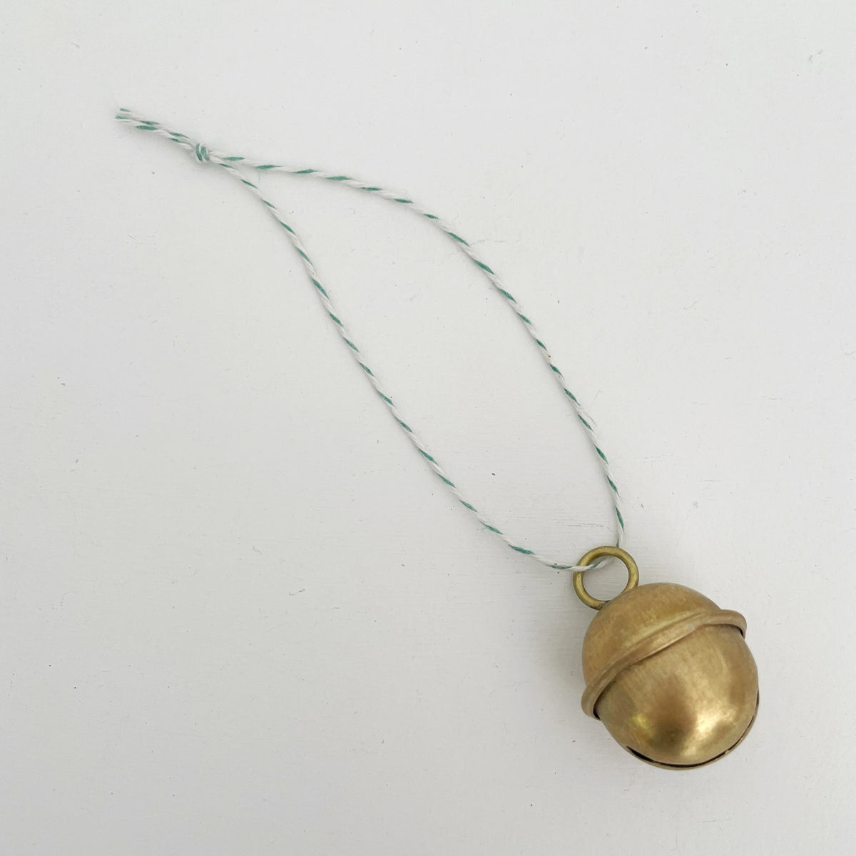 1 1/4" brass sleigh bell Christmas ornament : Green/Wht Bakers Twine